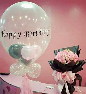 Happy Birthday printed hot air balloon with balloons stuffed inside and on the the stick accompanied with a 20 light pink roses bouquet