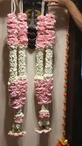 A pair of Garlands with White and light pink flowers beads at bottom and neck