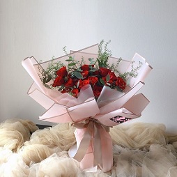 Twenty Red Roses with folds of pink paper wrapping
