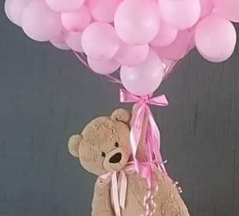 20 Pink Gas Balloon bouquet tied to the hand of a 12 inches Teddy bear